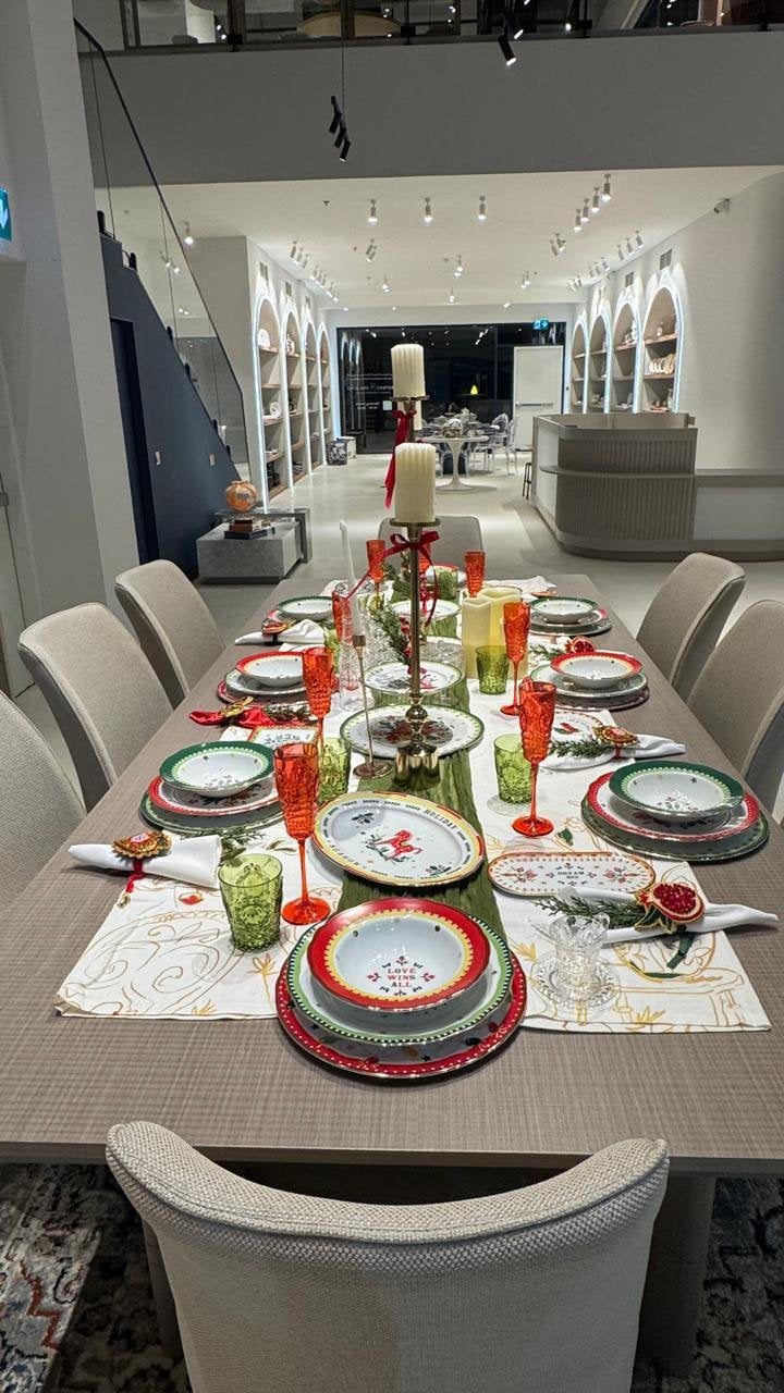 Inside the Amprio Milano Dubai showroom — a styled Italian tableware table running the length of the gallery