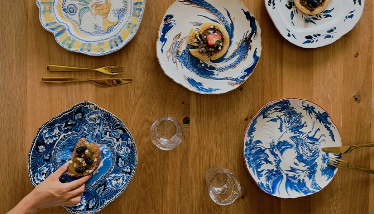 Seletti Hybrid porcelain plates mixing Eastern and Western motifs on a timber dining table
