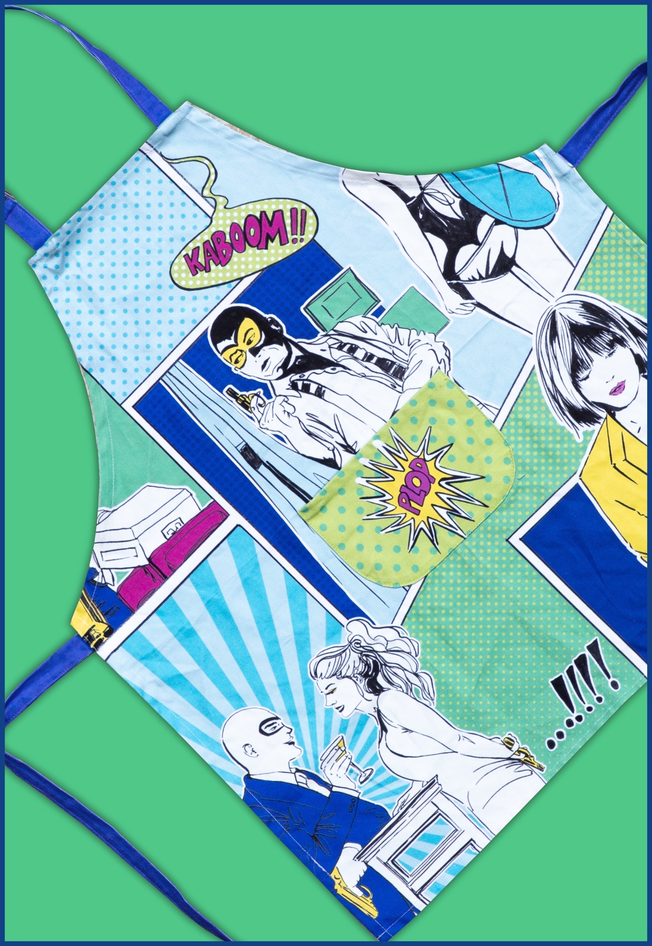 Gulp pop-art apron with comic panels and front pocket in blue-green tones — kitchen textile by Amprio Milano.