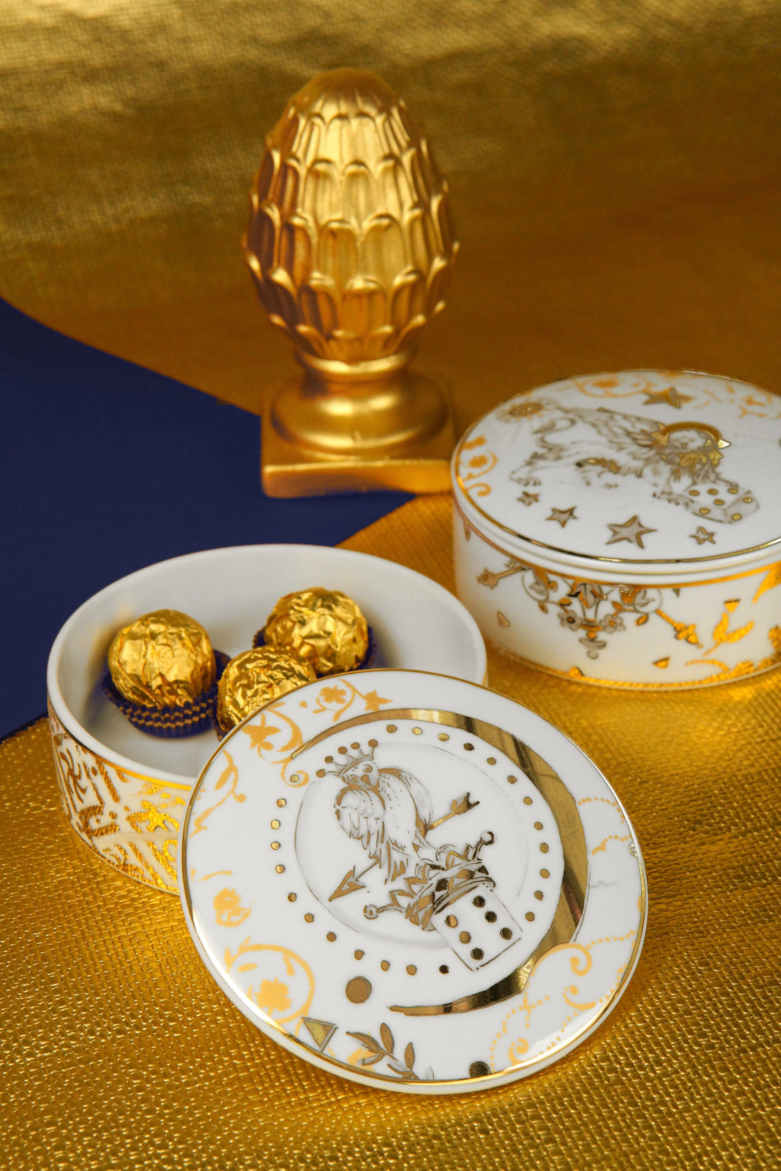 Kosmo round porcelain box with lid — gold celestial motifs and heraldic bird by Amprio Milano