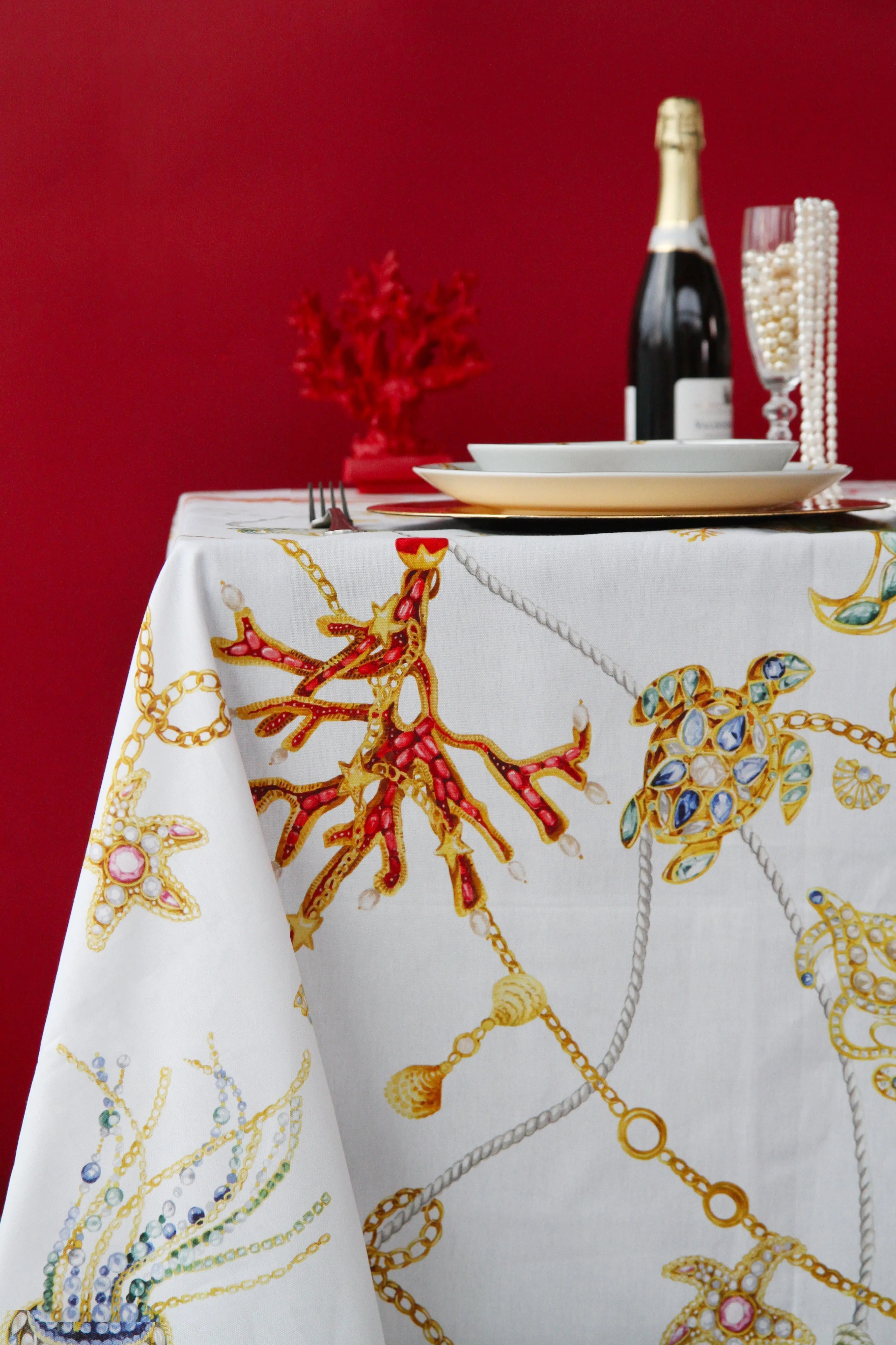Portofino tablecloth — white linen-look cloth with jeweled nautical motifs (coral, turtle, starfish, chains) by Amprio Milano