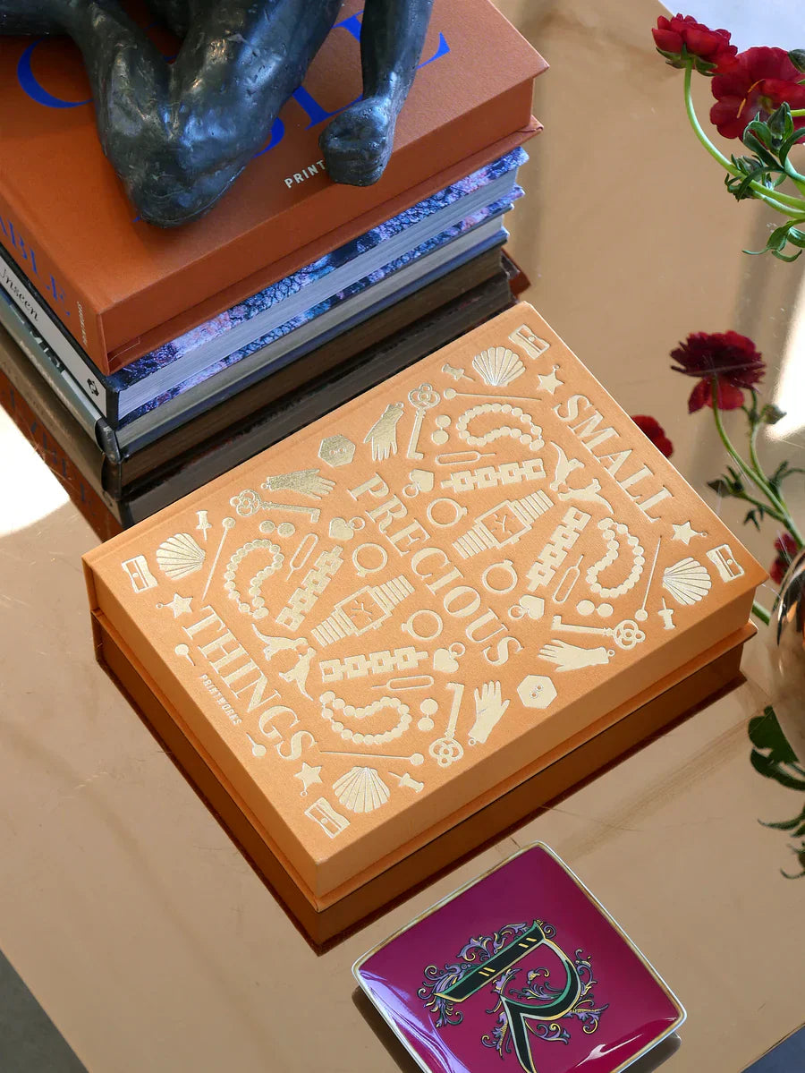 Printworks “Small Precious Things” storage box with gold-foil cover on a coffee table — curated by Amprio Milano.