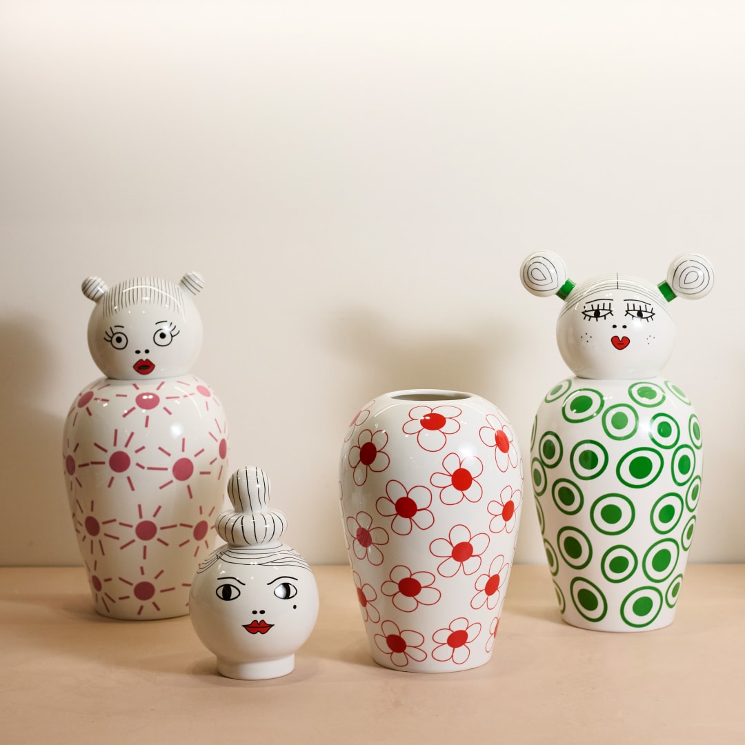 Seletti porcelain vases with whimsical faces and pink, red, green geometric patterns by Amprio Milano.